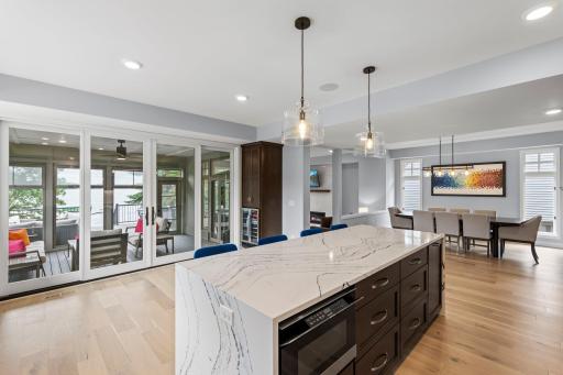 The heart of the home, this expansive kitchen blends sophisticated design with effortless connection to the dining, living and screened porch spaces.