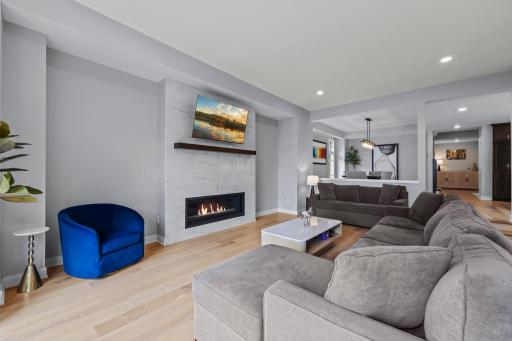 A beautifully appointed living room centered around the warmth of the fireplace and views of the lake.