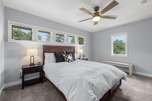 This beautifully appointed East bedroom is filled with natural light .