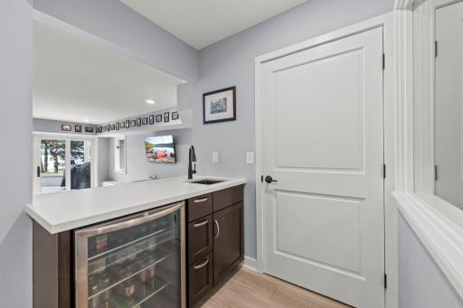 A quaint, yet stylish, lower-level bar creates an inviting destination for casual entertaining and relaxed evenings at home.