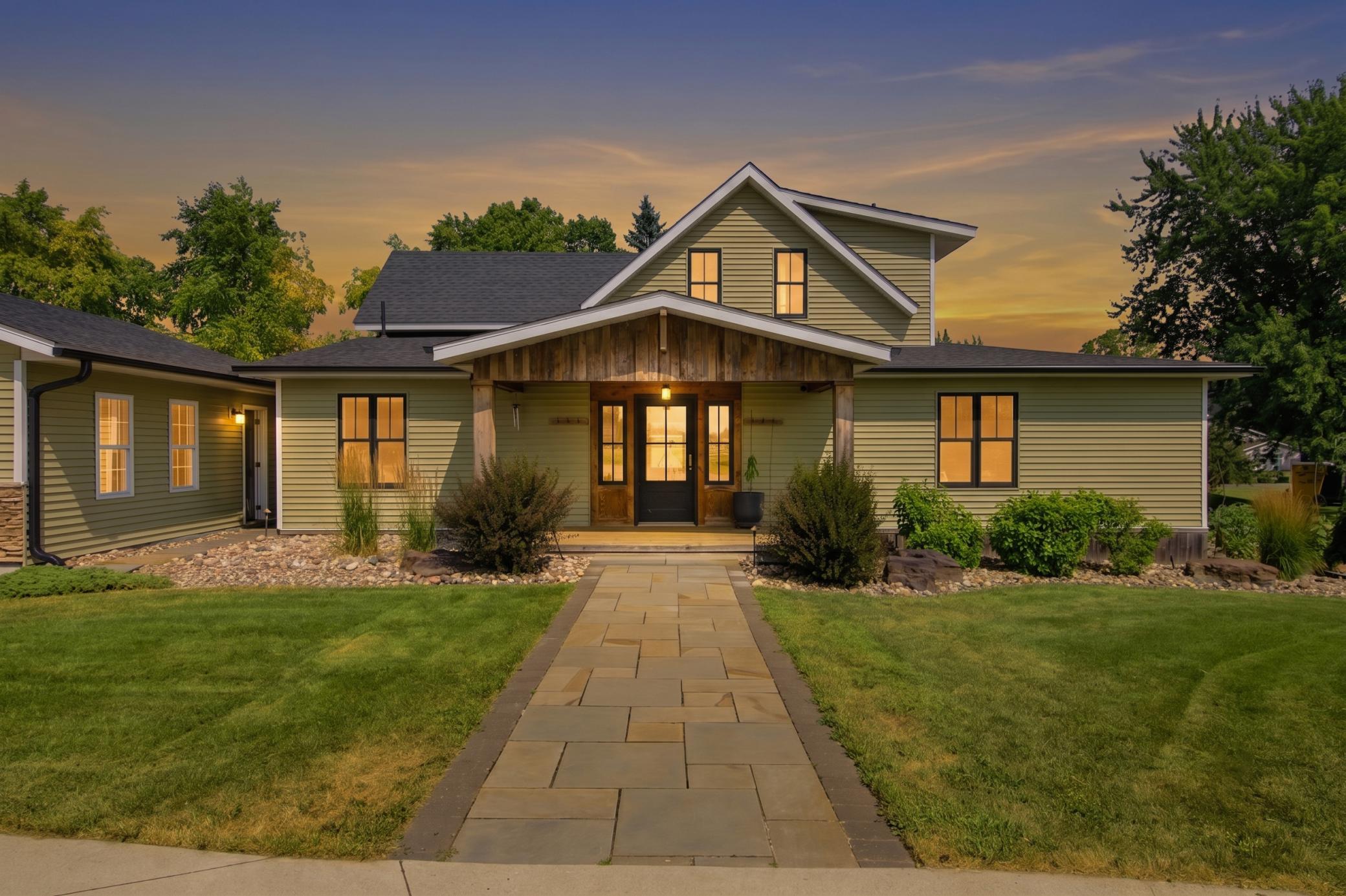 This beautifully landscaped home features a detached garage, an expansive driveway, and excellent curb appeal.