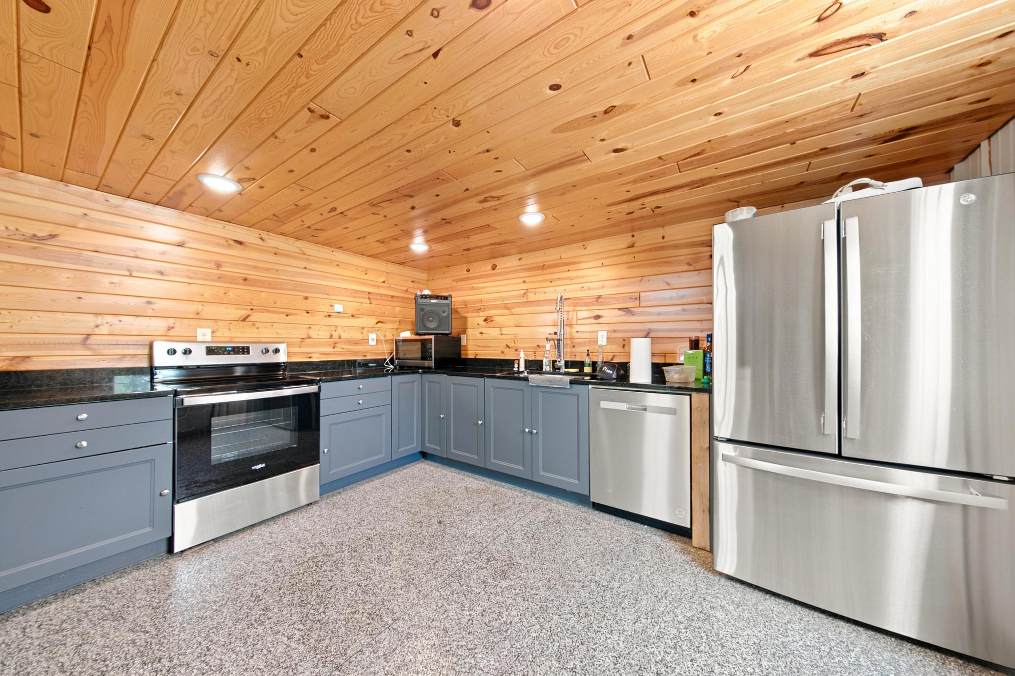 A massive outbuilding offers heated epoxy floors, incredible storage, full kitchen, bathroom with laundry , loft area, workshop space alongside a dedicated chicken coop.