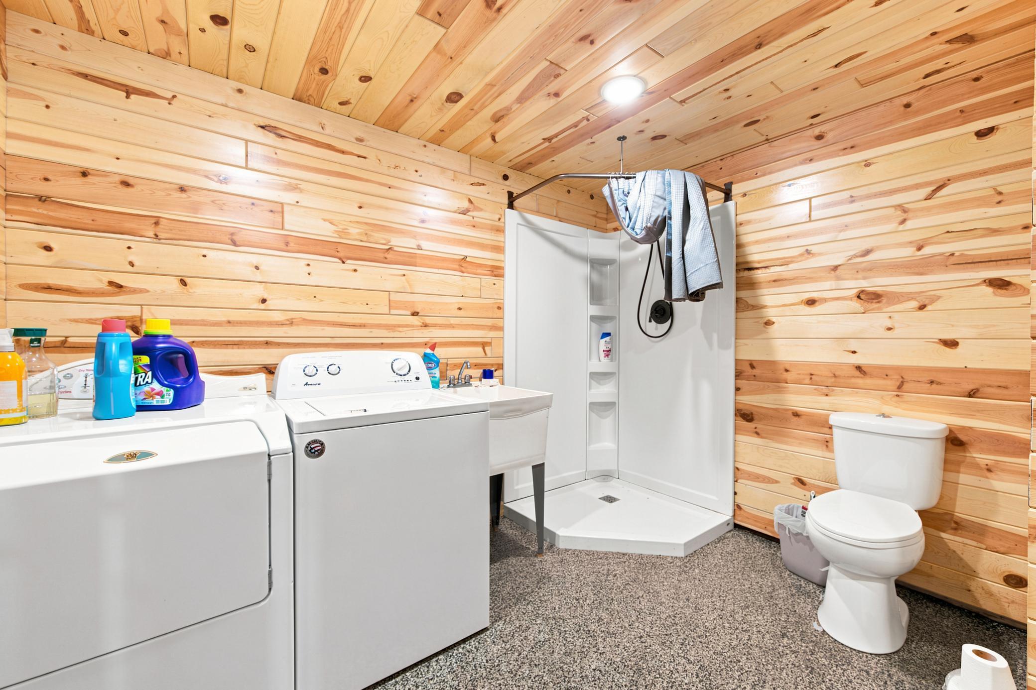 A massive outbuilding offers heated epoxy floors, incredible storage, full kitchen, bathroom with laundry , loft area, workshop space alongside a dedicated chicken coop.