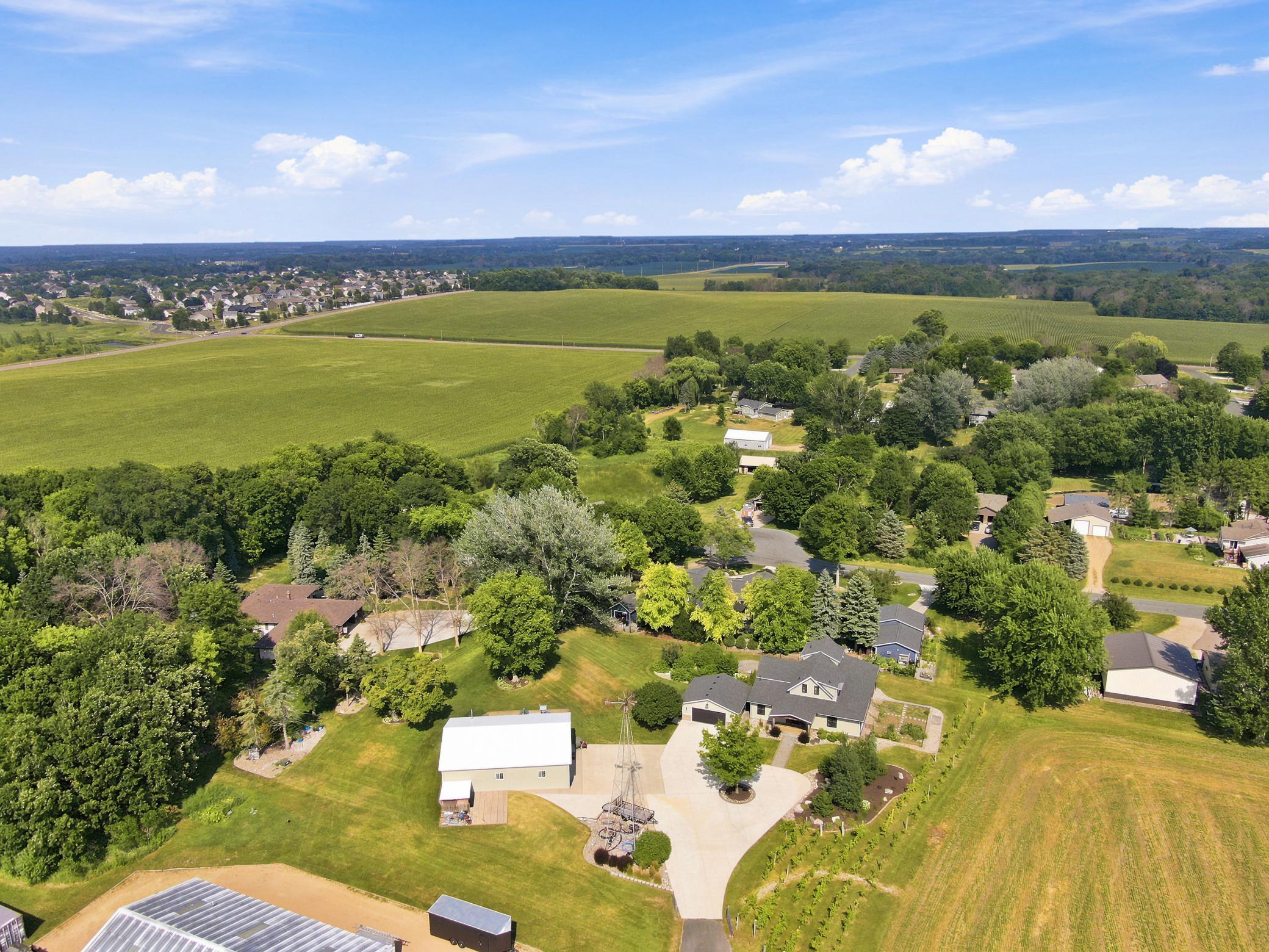 This breathtaking property features a beautifully updated home, a detached garage, a massive outbuilding, and its own private vineyard nestled on a sprawling lot with sweeping countryside views.