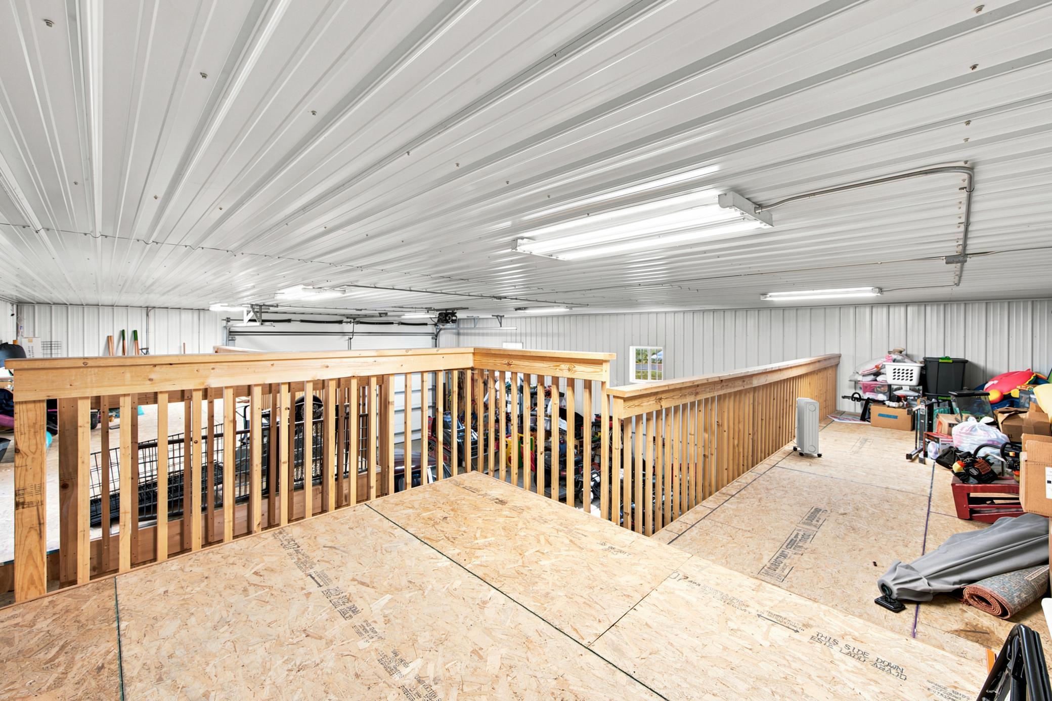 A massive outbuilding offers heated epoxy floors, incredible storage, full kitchen, bathroom with laundry , loft area, workshop space alongside a dedicated chicken coop..