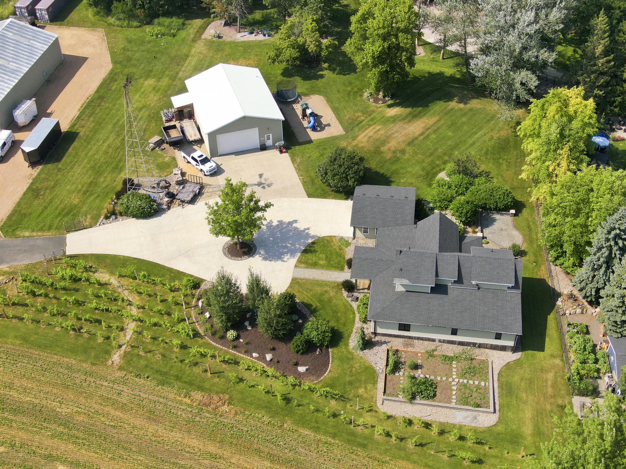 A massive outbuilding offers heated epoxy floors, incredible storage, full kitchen, bathroom with laundry , loft area, workshop space alongside a dedicated chicken coop.