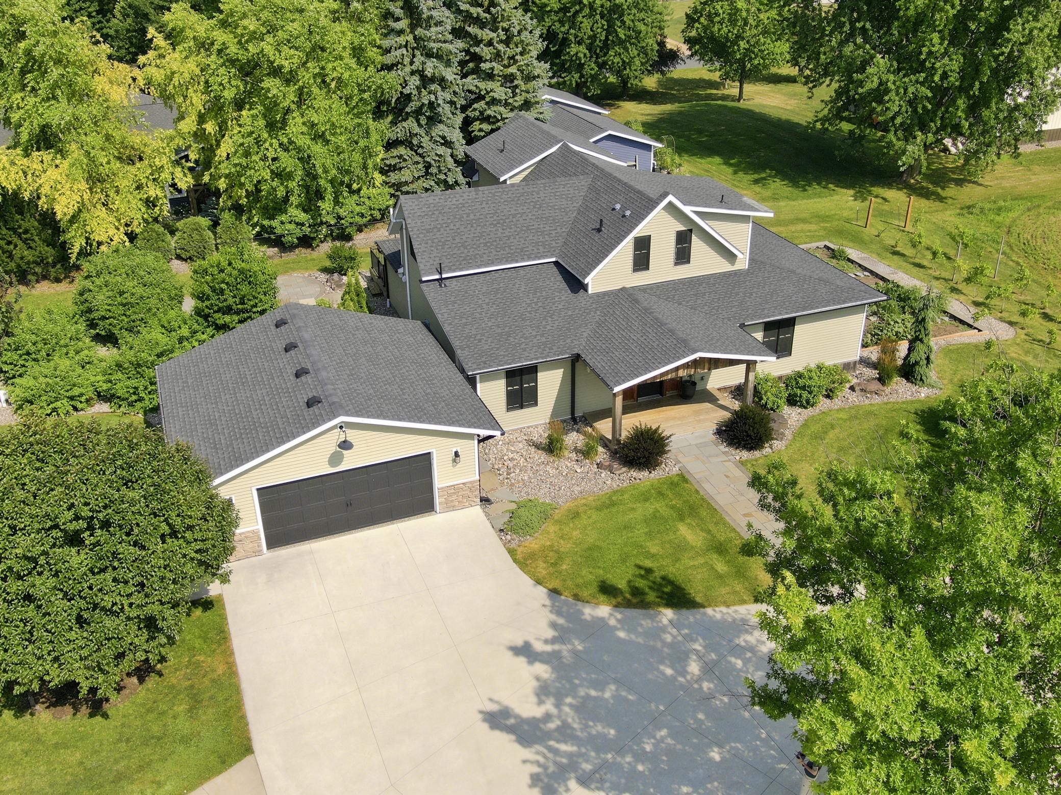 This beautiful home features a detached garage, an expansive driveway, and excellent curb appeal.