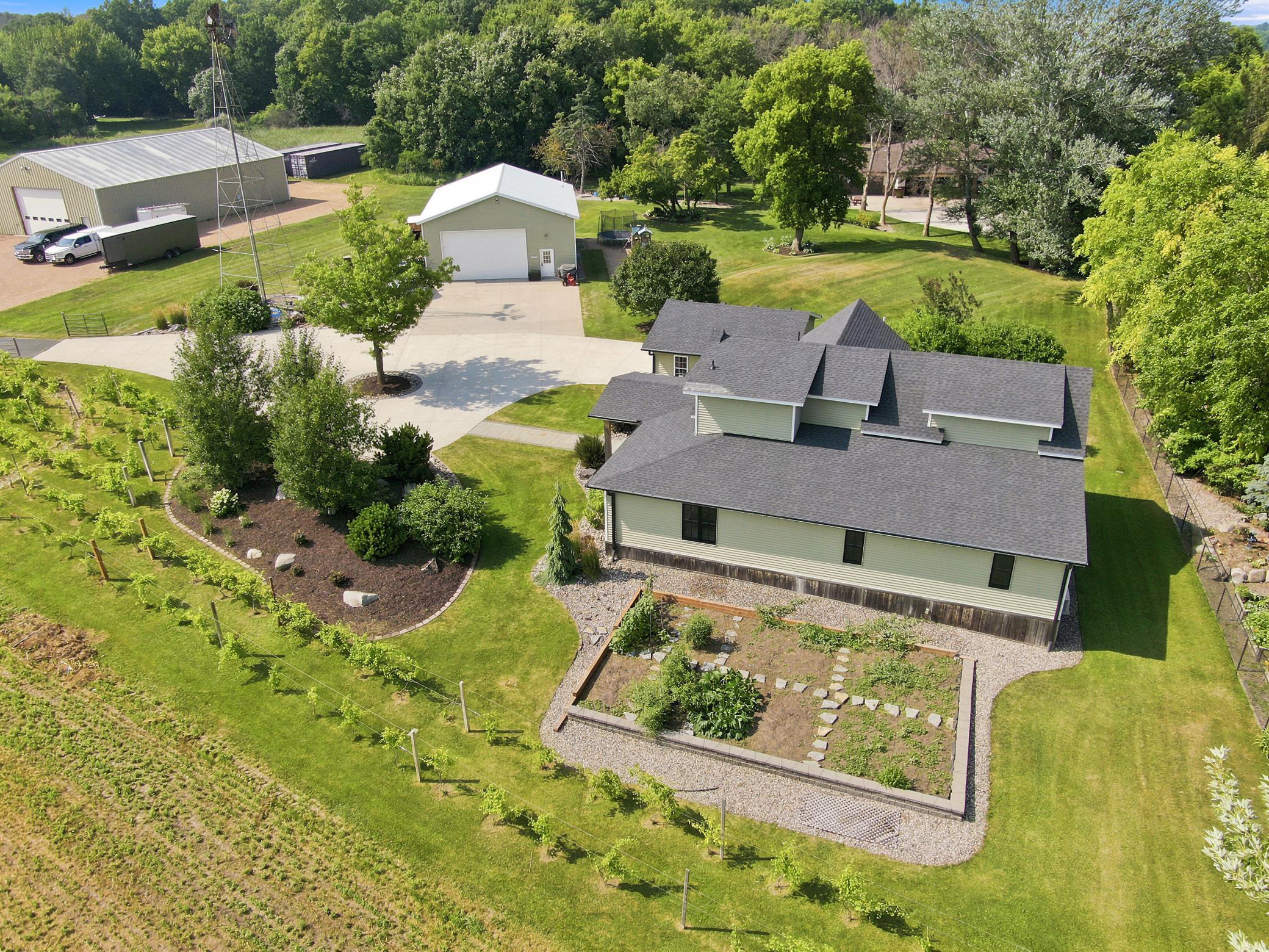 This breathtaking property features a beautifully updated home, a detached garage, a massive outbuilding, and its own private vineyard nestled on a sprawling lot with sweeping countryside views.