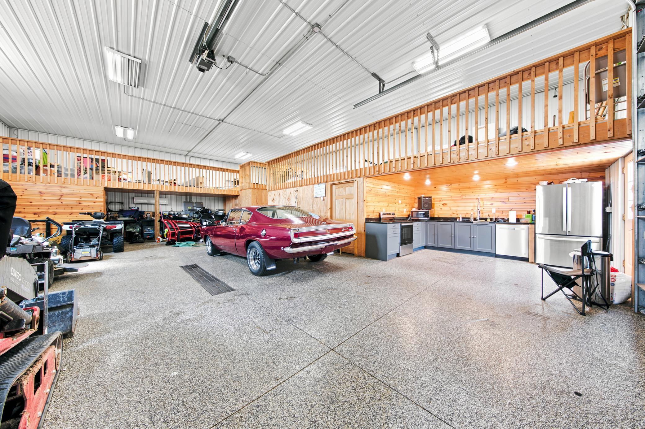A massive outbuilding offers heated epoxy floors, incredible storage, full kitchen, bathroom with laundry , loft area, workshop space alongside a dedicated chicken coop.