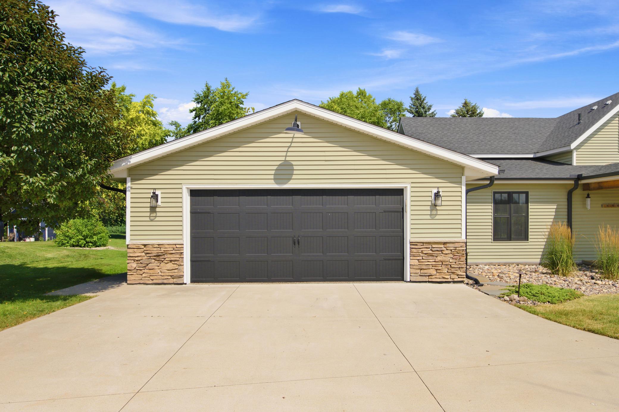 This fully insulated and heated detached 2-car garage features durable epoxy flooring, recessed lighting, and multiple bright windows that flood the space with natural light.