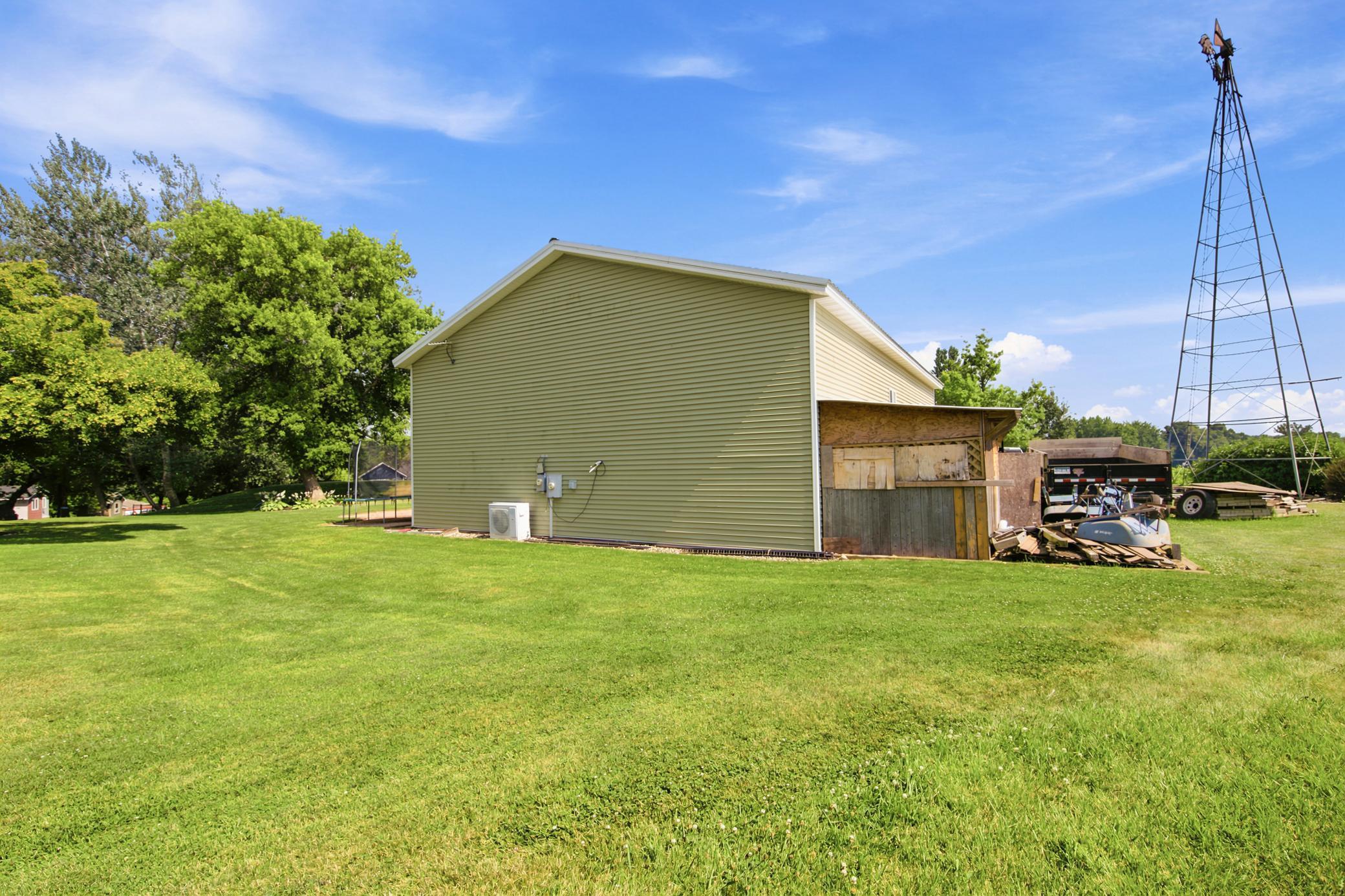A massive outbuilding offers heated epoxy floors, incredible storage, full kitchen, bathroom with laundry , loft area, workshop space alongside a dedicated chicken coop.