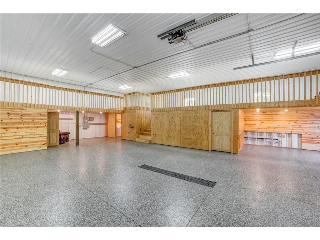 A massive outbuilding offers heated epoxy floors, incredible storage, full kitchen, bathroom with laundry , loft area, workshop space alongside a dedicated chicken coop.