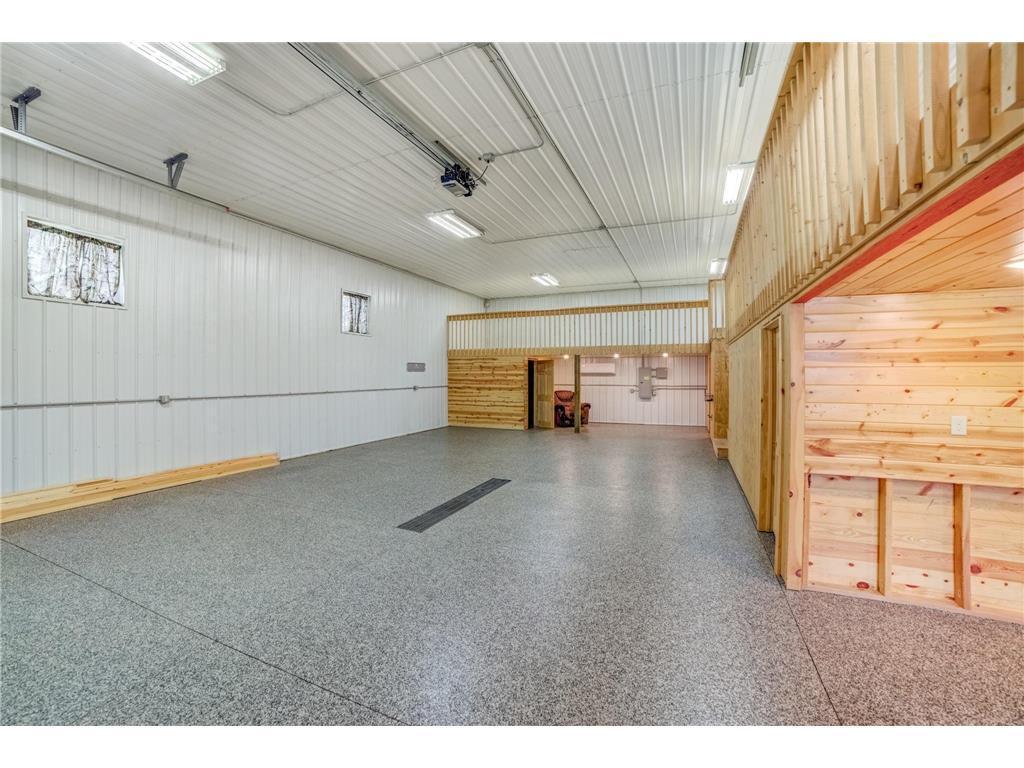 A massive outbuilding offers heated epoxy floors, incredible storage, full kitchen, bathroom with laundry , loft area, workshop space alongside a dedicated chicken coop.