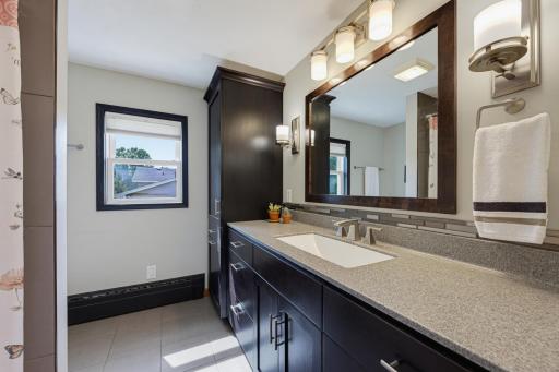 The full bathroom on the main floor features a dedicated linen cabinet.