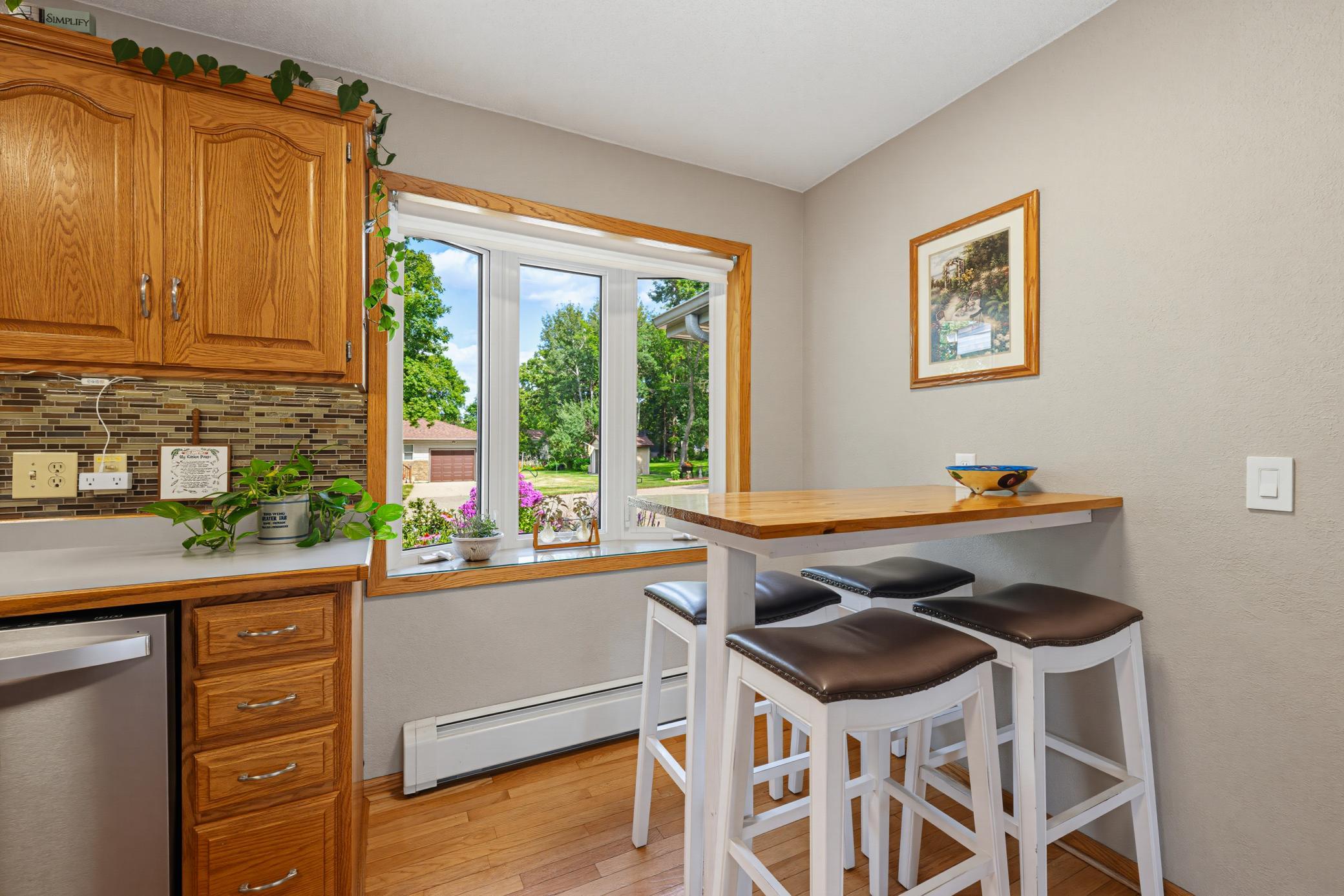 The kitchen features a dining area. Enjoy the view of the front yard through the bay window.