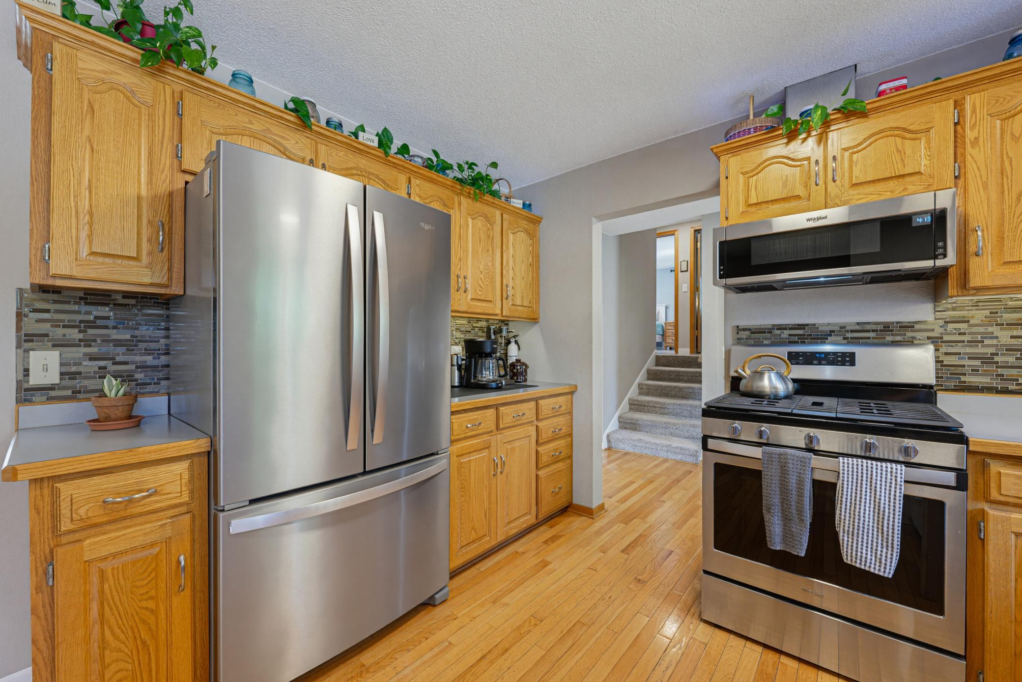 The kitchen includes a full suite of S.S. appliances includes a gas range, microwave, dishwasher, and refrigerator. A garbage disposal is also included.