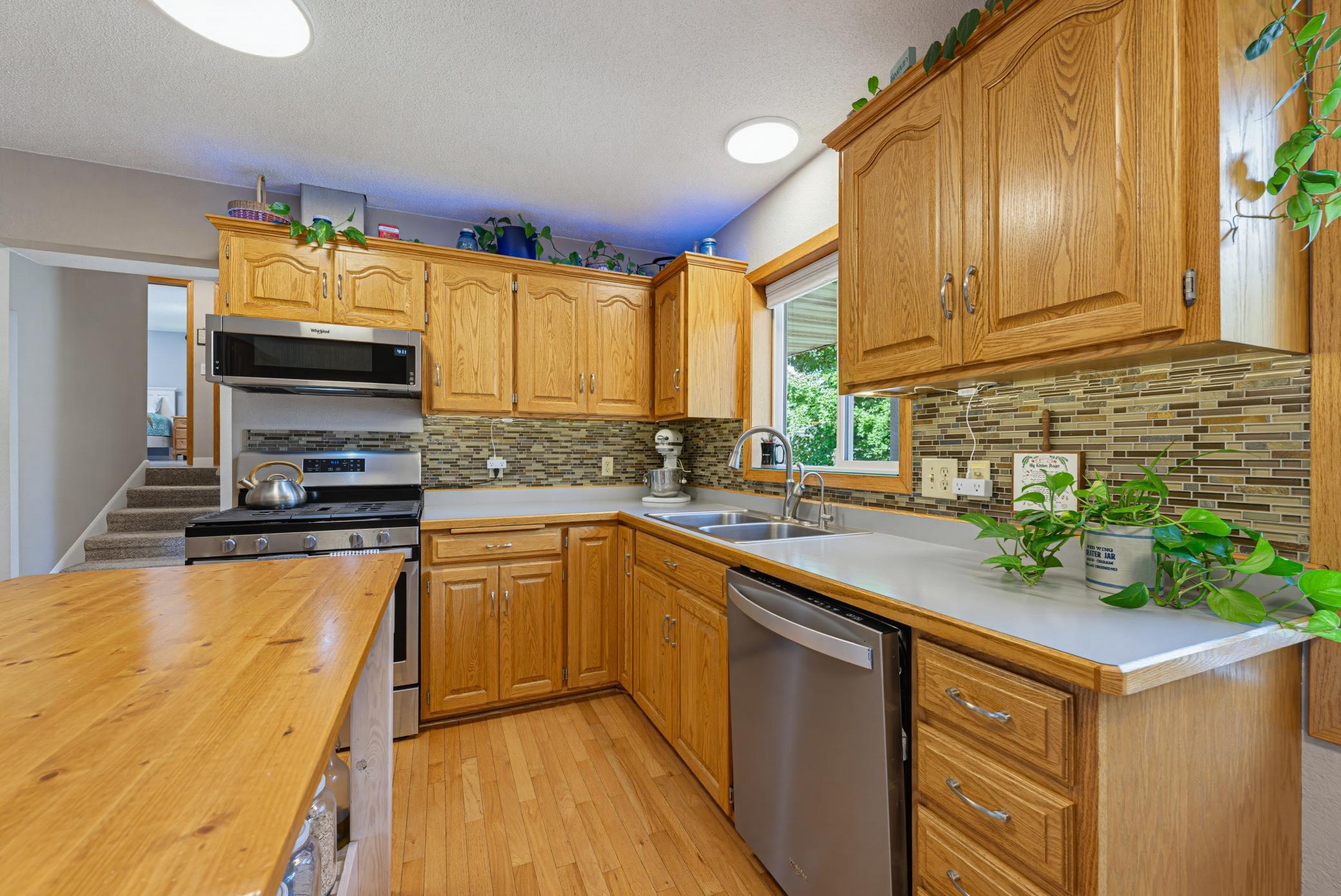 The kitchen features a full suite of S.S. appliances includes a gas range, microwave, dishwasher, and refrigerator. A garbage disposal is also included.