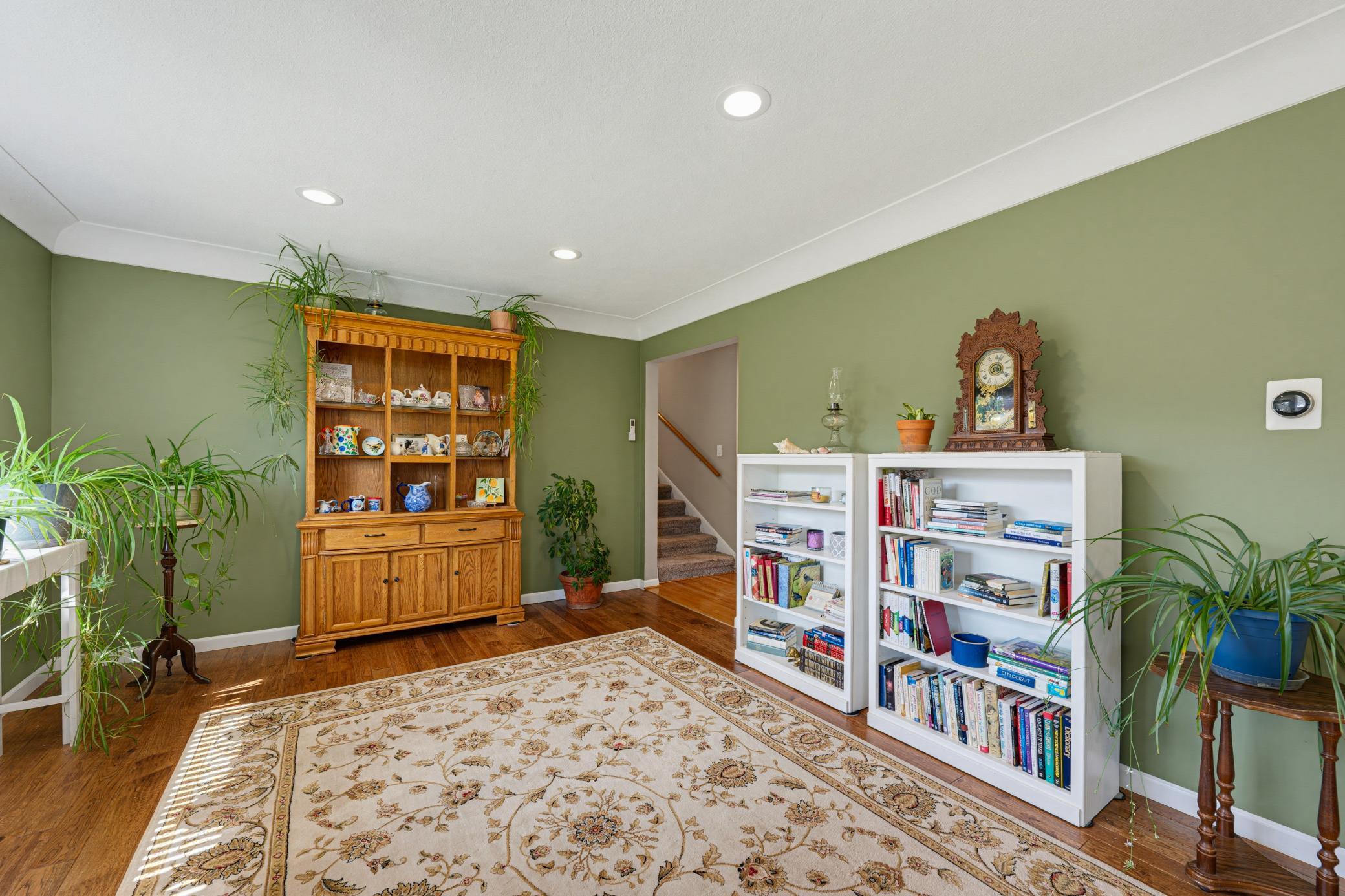 The living room features coved ceilings and modern recessed canister lighting.