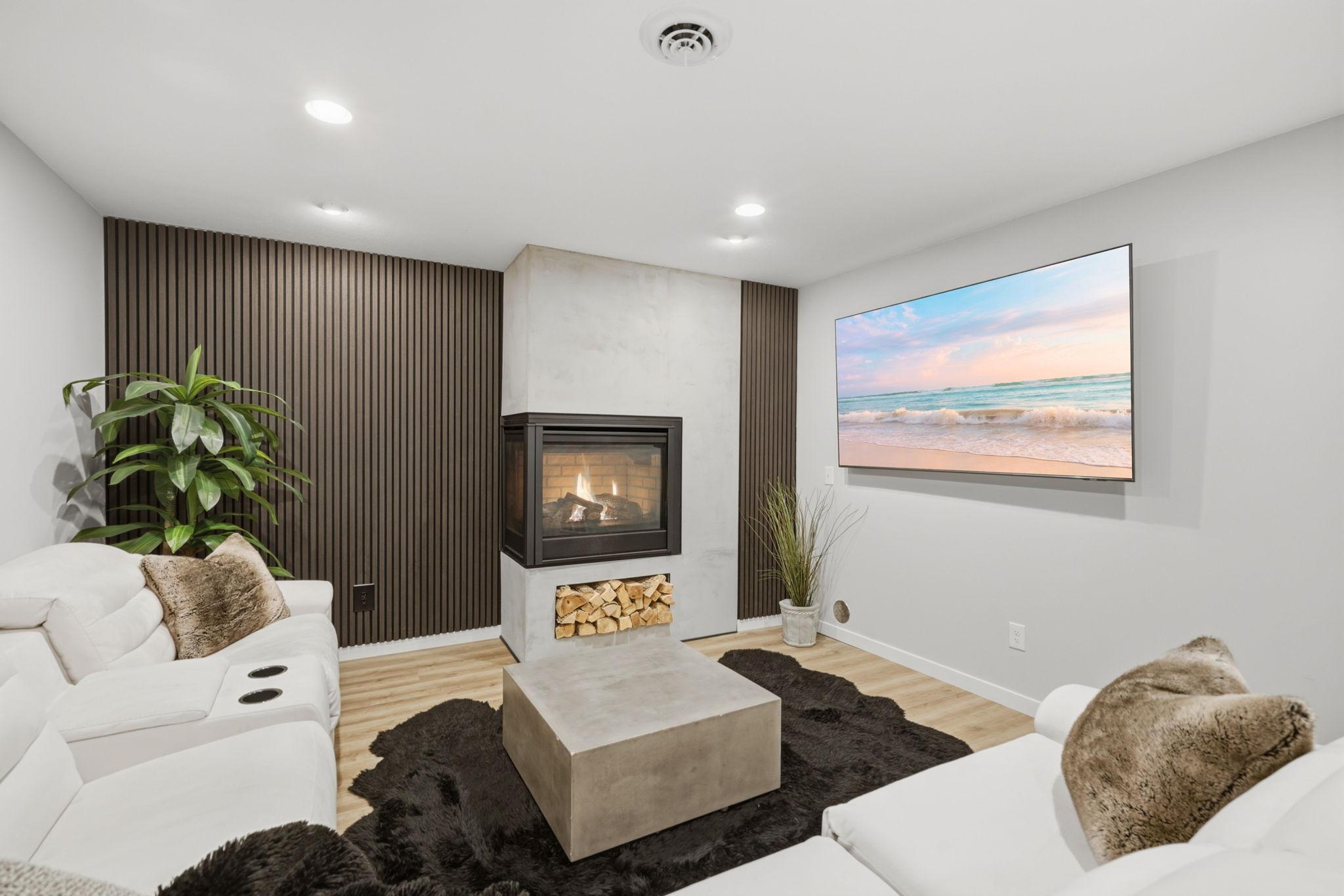 Newly finished custom lower level living room with gas fireplace