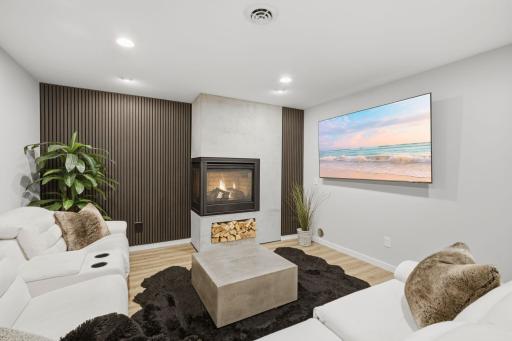 Newly finished custom lower level living room with gas fireplace