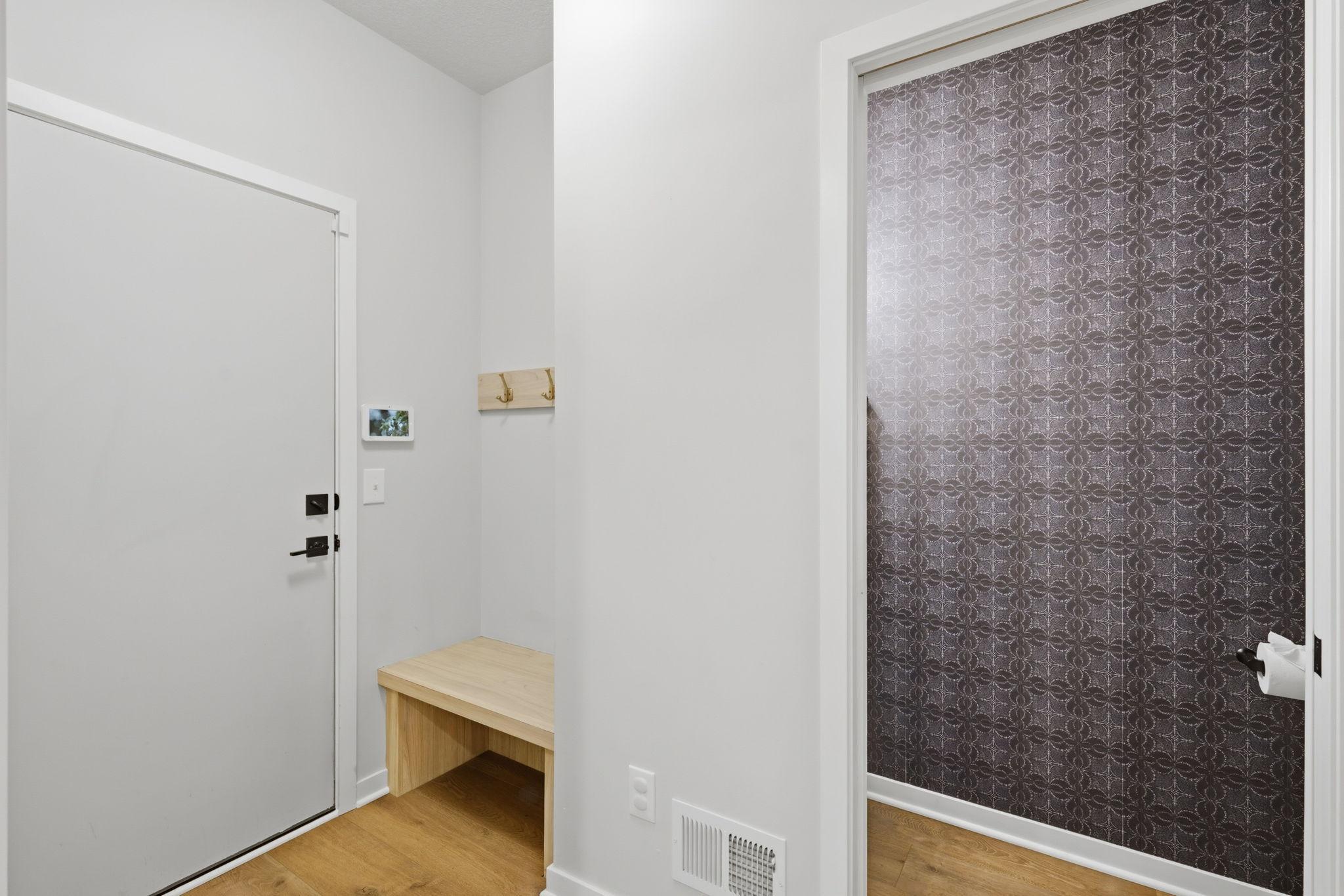 Convenient entry from the garage with half bath and custom bench