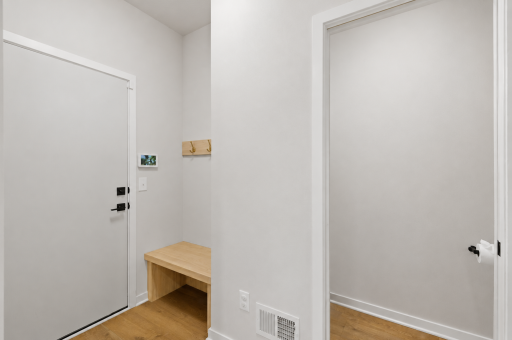 Convenient entry from the garage with half bath and custom bench
