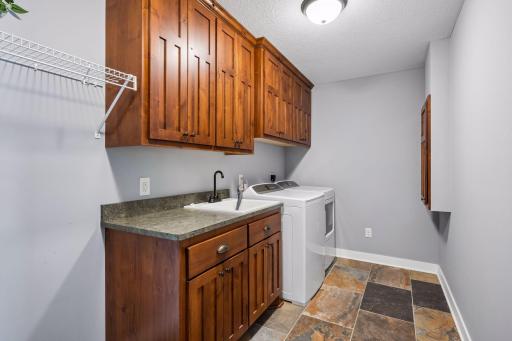 Laundry room complete with sink and tons of storage!