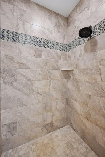 Primary bathroom has a tile walk-in shower.