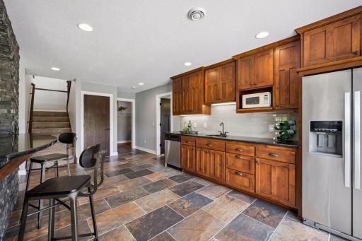 Lower level has a full wet bar! Complete with dishwasher, full refrigerator, and island seating!