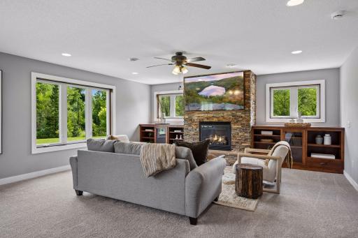Cozy family room with another stone floor to ceiling fireplace and built-ins.