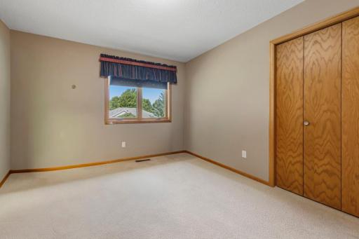 Second bedroom (unstaged) offers a window and large closet.