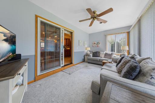 Sliding patio doors off the kitchen lead to a wonderful sunroom!