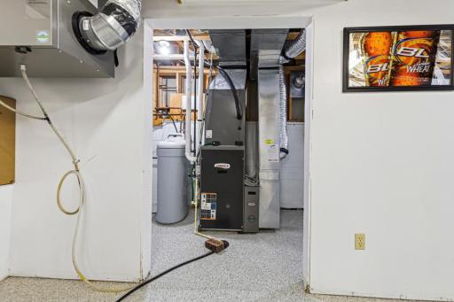 Lower level furnace with air-exchanger and water-softener