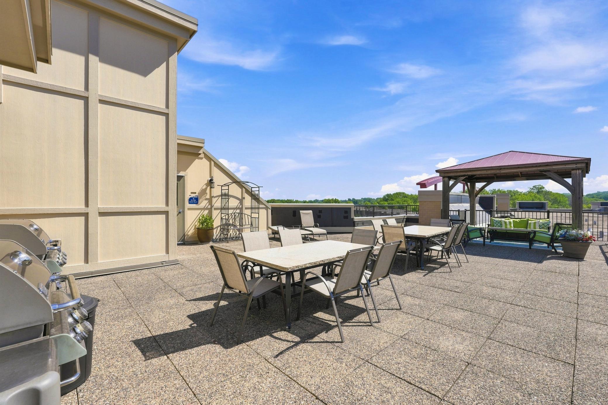 Rooftop balcony with grills, seating and views of fireworks on the 4th of July!