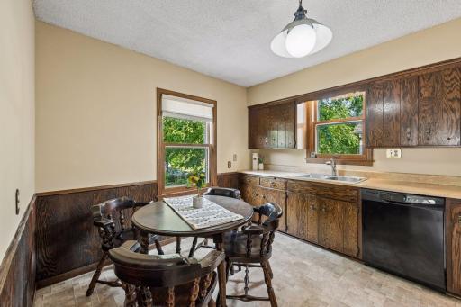 Eat-in kitchen with generous cabinet storage, ample counter space, double sink, and windows providing natural light.