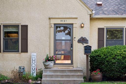 Welcoming front entrance with classic architectural details and established landscaping.