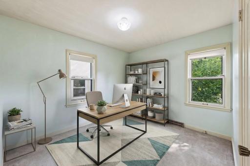 Virtually staged to showcase the potential use of this main-level bedroom as a comfortable home office or workspace. Virtually staged!