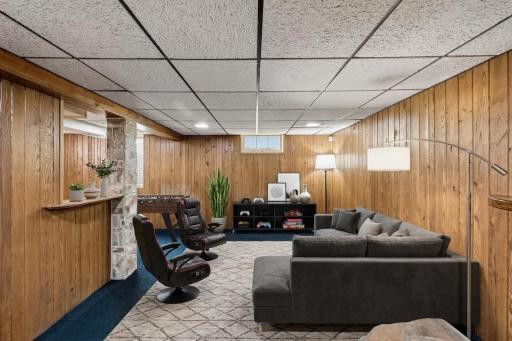Virtually staged to showcase the potential of this spacious lower level as a comfortable family room, media area, and game space. Virtually staged image.