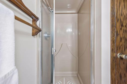 Upper-level bathroom features a separate walk-in shower.