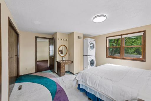 Upper-level bedroom with a unique layout, built-in shelving and drawers, plus a built-in makeup desk.