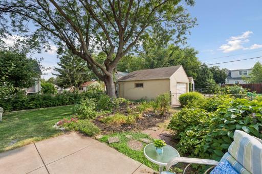 Beautiful backyard with mature trees, established landscaping, garden space, and a patio - plenty of room to relax, garden, and enjoy the outdoors.