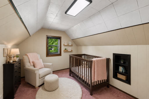 Another upper-level bedroom, virtually staged as a cozy nursery to showcase the possibilities for this charming space. Virtually staged image!