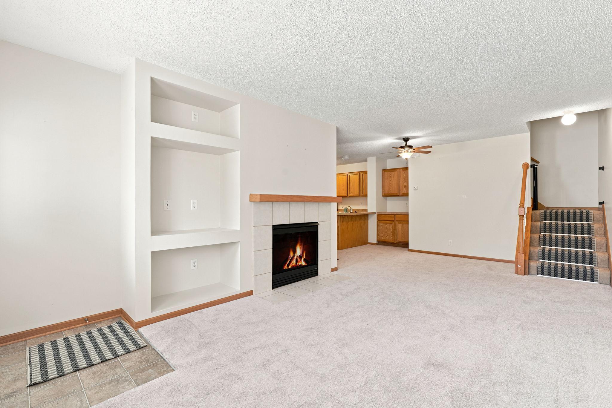 Built in and fireplace make for a cozy yet functional space.