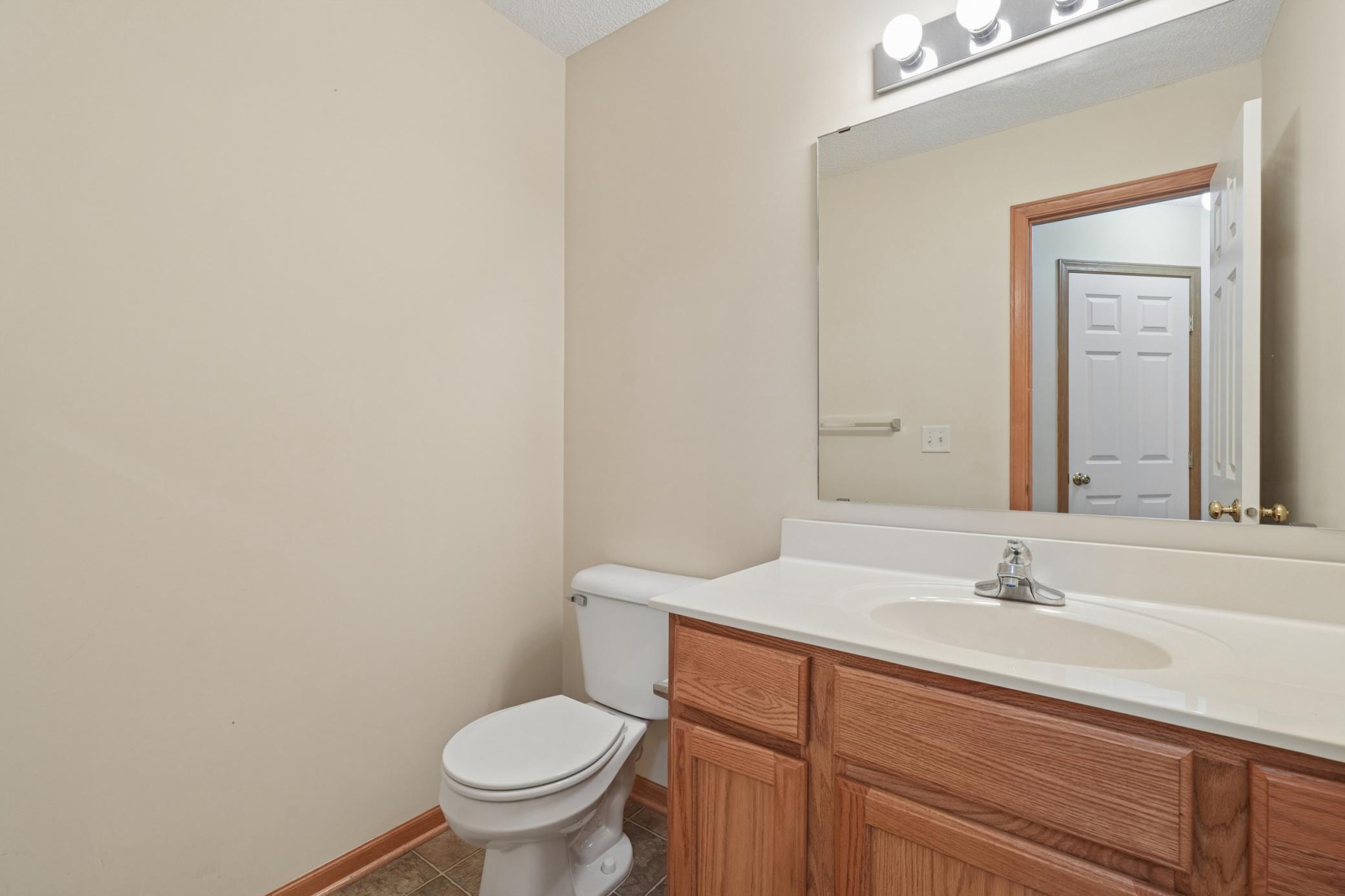 Half bath tucked in the corner behind the kitchen.