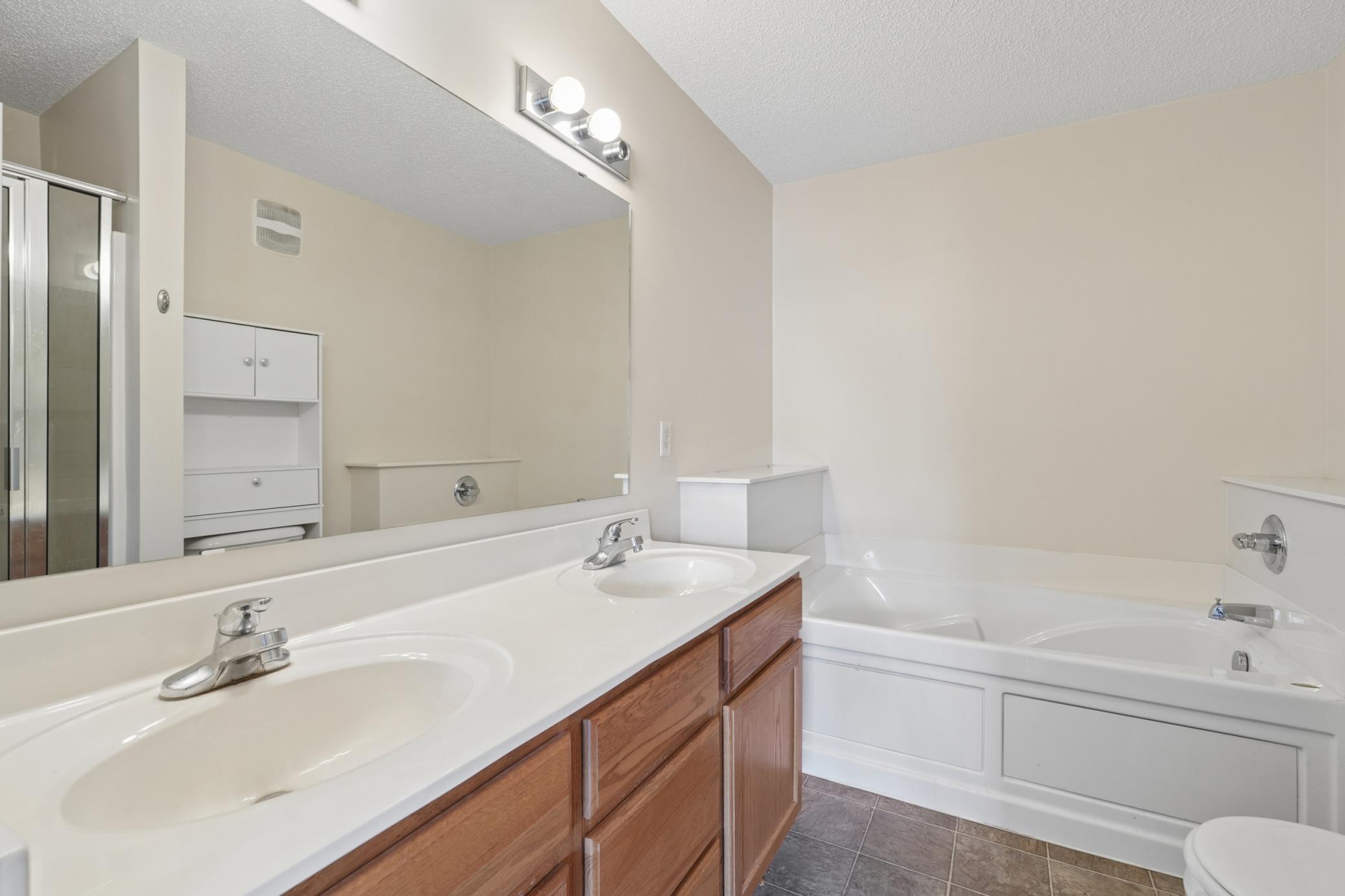 Nice double vanity, shower, and whirlpool tub.