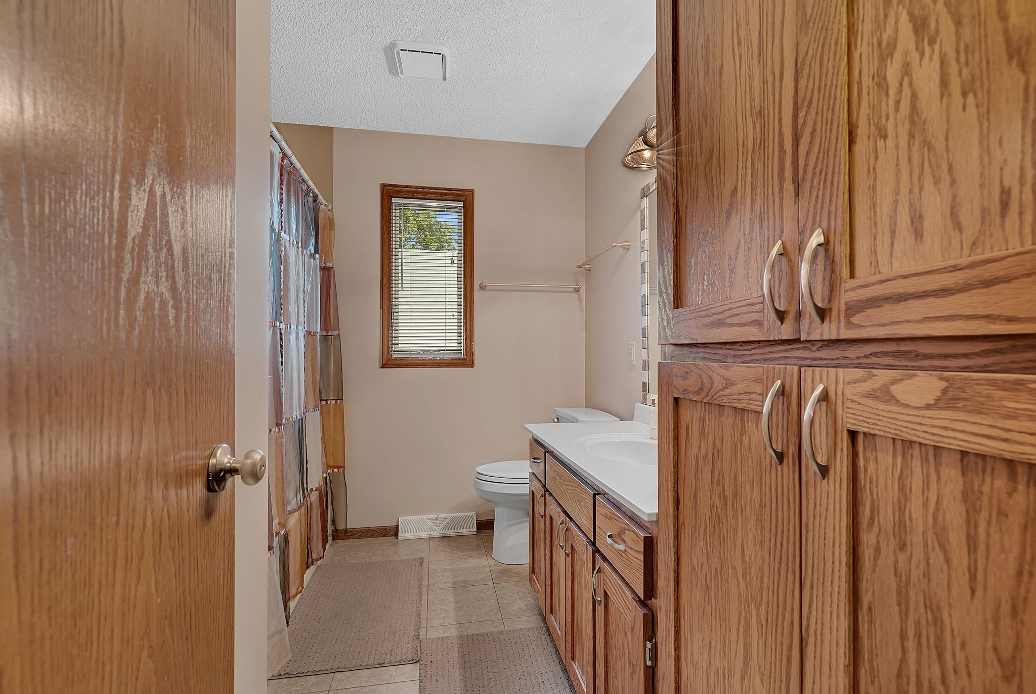 Another view of the upper-level full bath highlighting the storage space and thoughtful details throughout.