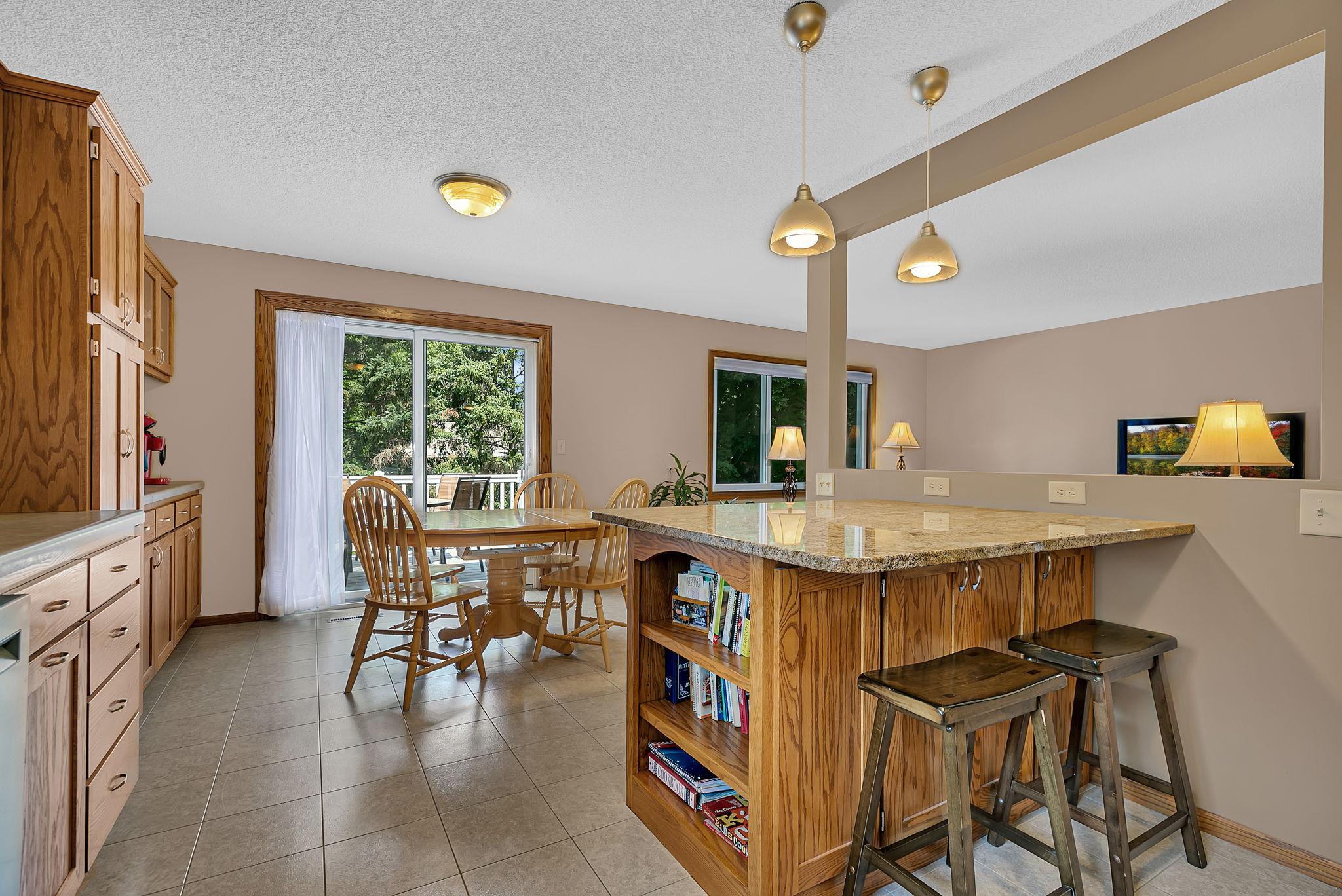 A view from the kitchen into the dining area, with an open flow that extends to the backyard deck and creates the perfect connection between indoor and outdoor living.