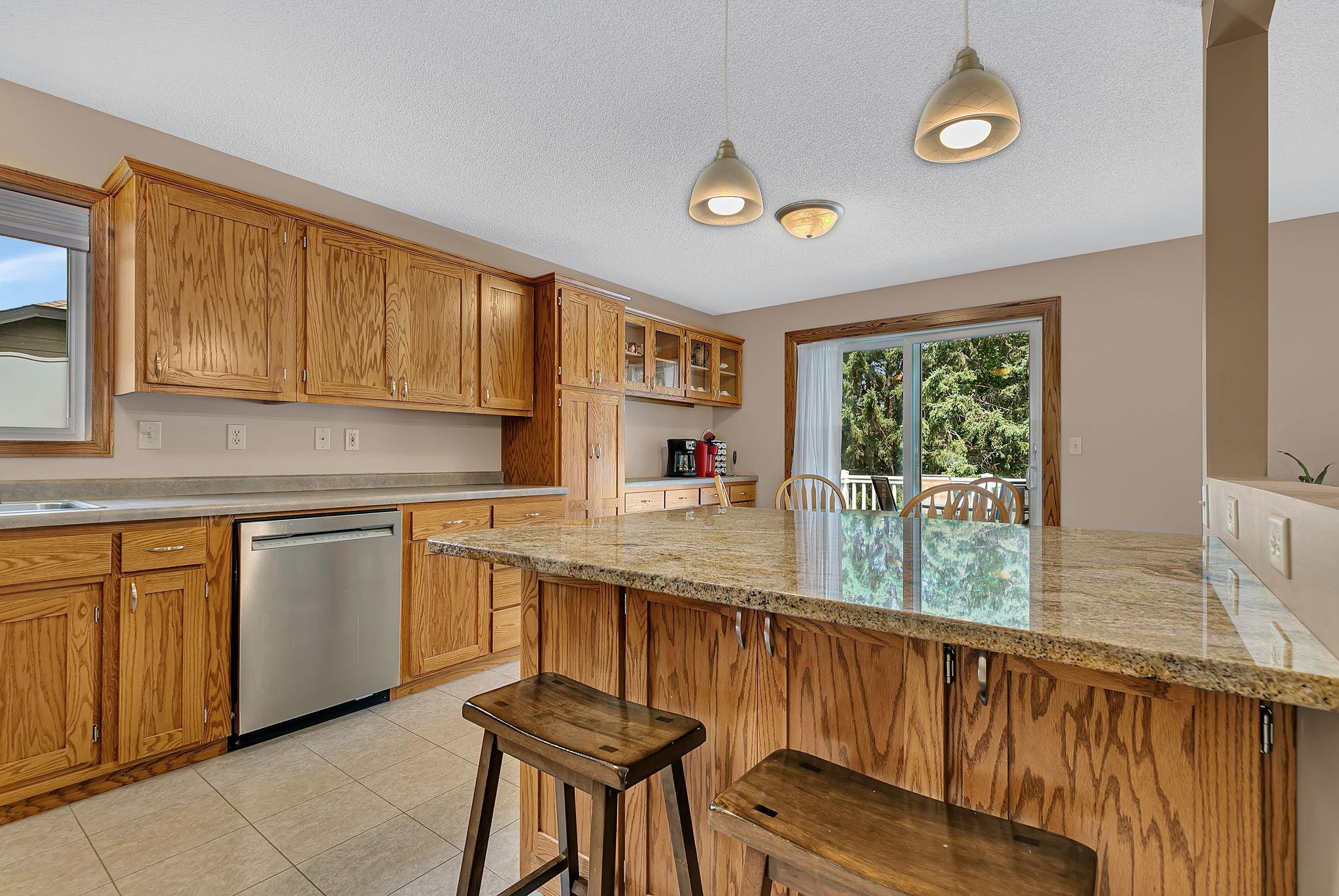 The spacious island offers additional seating, storage, and prep space, making it a functional centerpiece for the kitchen.