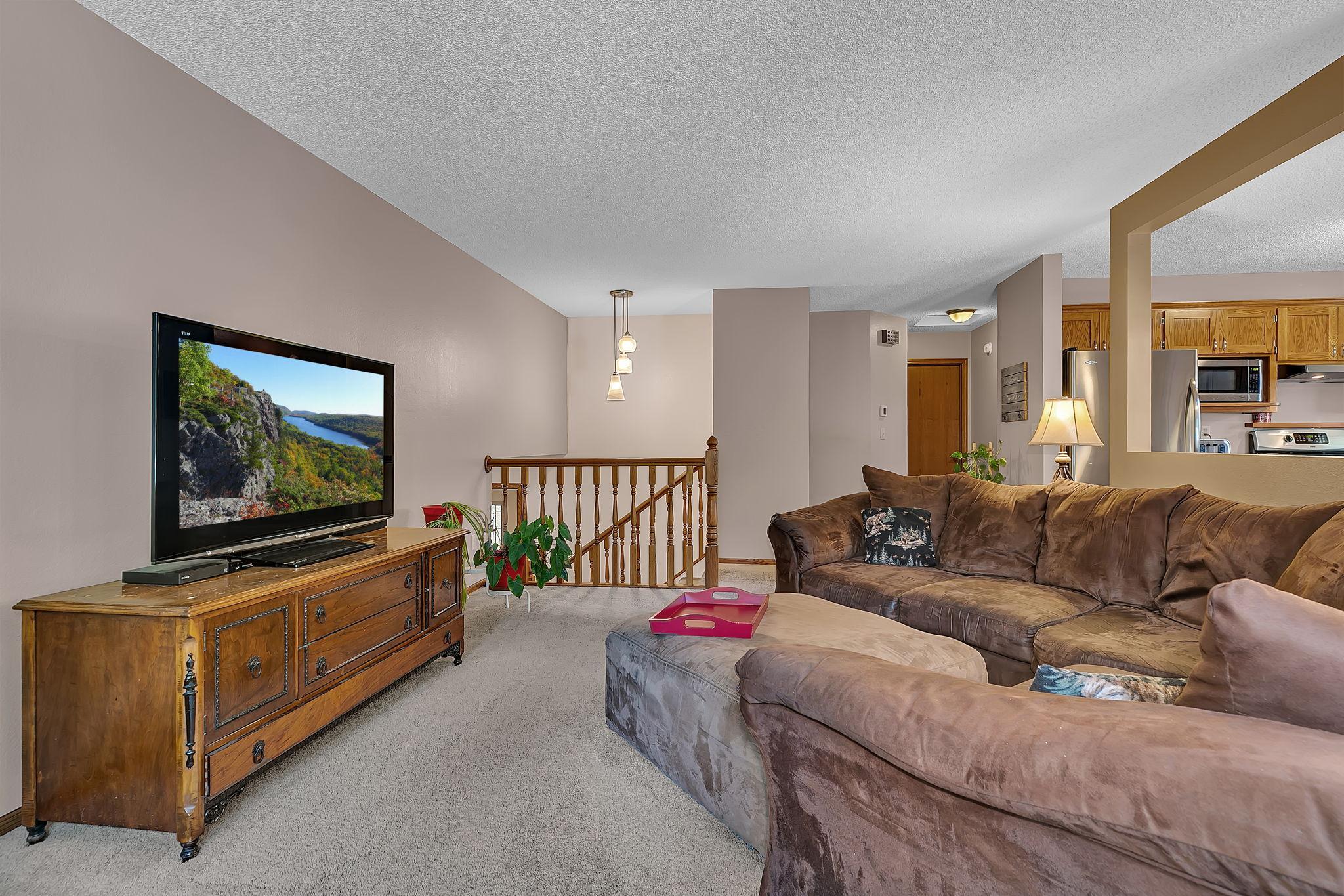 Another view of the living room showcasing the inviting space, natural light, and open flow throughout the main living area.