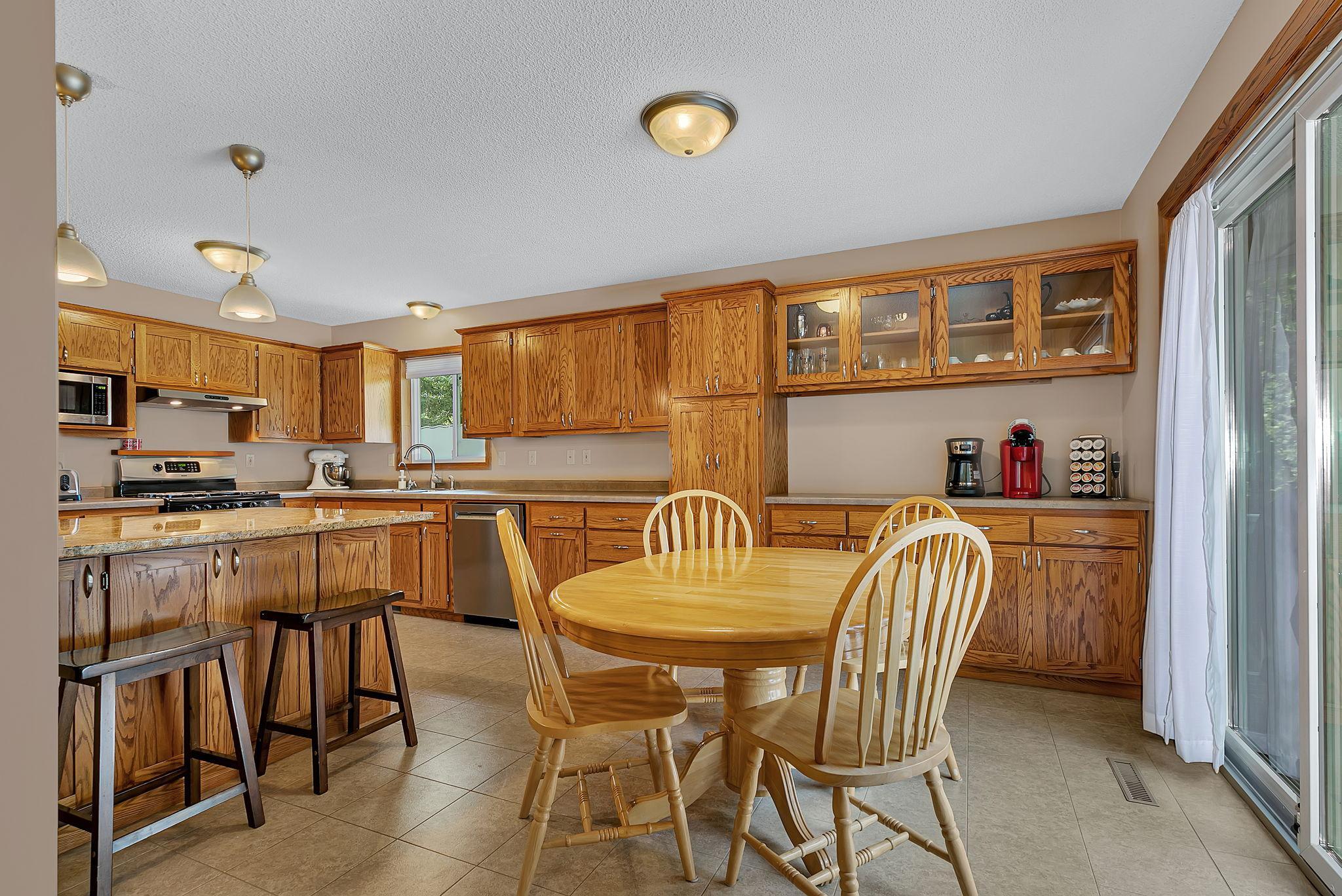 A look at the dining area and renovated kitchen featuring added cabinet and countertop space—perfect for a buffet station, coffee bar, or extra workspace.